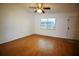 Cozy living room with wood floors, ceiling fan, and a bright window at 125 Water Front Way # 200, Altamonte Springs, FL 32701