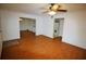 Living area with wood floors, ceiling fan, open to kitchen and dining areas at 125 Water Front Way # 200, Altamonte Springs, FL 32701