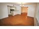 Living area with wood floors, chandelier and sightlines into the kitchen and dining areas at 125 Water Front Way # 200, Altamonte Springs, FL 32701