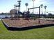 Community playground with slides, swings, and play equipment in a fenced area with a lake view for Gathering enjoyment at 125 Water Front Way # 200, Altamonte Springs, FL 32701