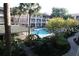 Community pool area with lush landscaping and multiple palm trees at 125 Water Front Way # 200, Altamonte Springs, FL 32701