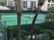 View of the community's tennis court, with lush greenery framing the court for a private and serene playing experience at 125 Water Front Way # 200, Altamonte Springs, FL 32701