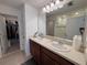 Bathroom features a double sink vanity, large mirror, and walk-in shower at 1258 Wispy Cypress Drive Dr, Kissimmee, FL 34746