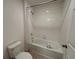 Clean bathroom featuring a tub/shower combination with white tiles and a standard toilet at 1258 Wispy Cypress Drive Dr, Kissimmee, FL 34746
