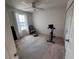 Carpeted bedroom featuring a ceiling fan, a comfortable chair, and a mounted exercise bike at 1258 Wispy Cypress Drive Dr, Kissimmee, FL 34746