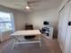 Bright bedroom featuring a ceiling fan, a modern computer setup, and a comfortable brown chair at 1258 Wispy Cypress Drive Dr, Kissimmee, FL 34746