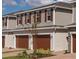 Charming townhomes with neutral siding, brown shutters, and brick paver driveways at 1258 Wispy Cypress Drive Dr, Kissimmee, FL 34746