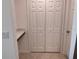 Hallway featuring closet doors and a small built-in desk at 1258 Wispy Cypress Drive Dr, Kissimmee, FL 34746
