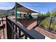 Community playground with shade structure over slides and play equipment, surrounded by black metal fence and mulch at 1258 Wispy Cypress Drive Dr, Kissimmee, FL 34746