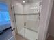Modern walk-in shower with glass door and tiled walls, and modern fixtures at 1258 Wispy Cypress Drive Dr, Kissimmee, FL 34746