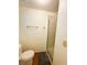 Simple bathroom featuring a toilet, towel bar, and walk-in shower with a frosted glass door at 129 Dogwood Trl, Leesburg, FL 34748