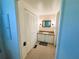 Small bathroom features a vanity with a sink, mirror, lighting, and built in closet for storage at 129 Dogwood Trl, Leesburg, FL 34748