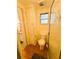 Bathroom with toilet, shower, built-in cabinet, and access to a second sink area at 129 Dogwood Trl, Leesburg, FL 34748