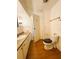 Bathroom with vanity, sink, toilet, towel rack and cabinet providing storage and essential amenities at 129 Dogwood Trl, Leesburg, FL 34748