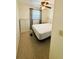 Comfortable bedroom featuring neutral carpet, a large window, and ample closet space at 129 Dogwood Trl, Leesburg, FL 34748