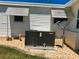 Close up of the property's HVAC unit, electrical box, and satellite dish at 129 Dogwood Trl, Leesburg, FL 34748