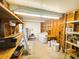Utility area with a washer, shelving units, and storage area at 129 Dogwood Trl, Leesburg, FL 34748