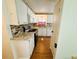 Efficient kitchen featuring white cabinets, stainless steel appliances, and a tile backsplash at 129 Dogwood Trl, Leesburg, FL 34748