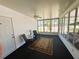 Enclosed lanai with ceiling fan, ample light, seating and a golf cart view at 129 Dogwood Trl, Leesburg, FL 34748