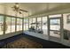 Comfortable enclosed lanai with view to street and golf cart at 129 Dogwood Trl, Leesburg, FL 34748