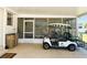 Relaxing screened lanai with a golf cart, with an outdoor living space at 129 Dogwood Trl, Leesburg, FL 34748