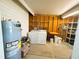 Utility room with washer, dryer, water heater and storage racks at 129 Dogwood Trl, Leesburg, FL 34748