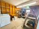 Utility room with washer, dryer, storage and shelves for convenience at 129 Dogwood Trl, Leesburg, FL 34748