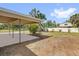 Spacious backyard featuring a covered patio with a white fence and green foliage at 1600 Hart Ln, Orlando, FL 32804
