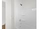 Clean white bathroom showcasing a tub/shower with storage shelves and a modern shower head fixture at 1600 Hart Ln, Orlando, FL 32804