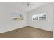 Bright bedroom with laminate flooring, fan and two windows providing lots of natural light at 1600 Hart Ln, Orlando, FL 32804