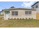 Front exterior view with a freshly landscaped yard, complemented by a light blue front door and stone facade at 1600 Hart Ln, Orlando, FL 32804