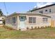 Charming single-story home with a light blue front door and shutters, set against a well-maintained lawn at 1600 Hart Ln, Orlando, FL 32804