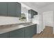 Modern kitchen with green cabinetry, light countertop, stainless sink, and new appliances at 1600 Hart Ln, Orlando, FL 32804