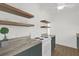 Well-lit kitchen featuring floating shelves, granite countertops and green cabinets at 1600 Hart Ln, Orlando, FL 32804