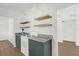 Charming kitchen showcasing wooden floating shelves, granite counters, and a bright white ceiling fan at 1600 Hart Ln, Orlando, FL 32804