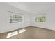 Sunlit living room features new flooring and fresh, white paint at 1600 Hart Ln, Orlando, FL 32804