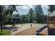 Community playground featuring a slide, picnic tables, and a basketball court surrounded by green trees at 1600 Hart Ln, Orlando, FL 32804