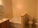 Bathroom features a soaking tub and toilet at 1810 Centennial Ave, St Cloud, FL 34769