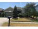 Home's exterior features well-maintained lawn, mature landscaping, and inviting curb appeal at 1810 Centennial Ave, St Cloud, FL 34769
