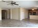 Open-concept living room boasts tile floors and connects seamlessly to the kitchen at 1810 Centennial Ave, St Cloud, FL 34769