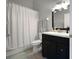 Cozy bathroom with a shower-tub combination, dark wood vanity, and updated fixtures at 1833 Courtland St, Orlando, FL 32804