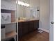 Bathroom vanity with a stylish vessel sink, dark wood cabinets, and updated lighting fixture at 1833 Courtland St, Orlando, FL 32804