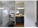 Bright bathroom featuring a glass shower, storage shelves, and a vessel sink vanity at 1833 Courtland St, Orlando, FL 32804