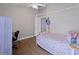 Bedroom featuring a ceiling fan, desk, and a cozy bed with a decorative bedspread at 1833 Courtland St, Orlando, FL 32804