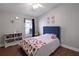 Bedroom featuring a plush bed with a blue headboard, a window, and decoratively adorned walls at 1833 Courtland St, Orlando, FL 32804