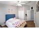 Spacious bedroom featuring a plush bed with a blue headboard, closet, and decoratively adorned walls at 1833 Courtland St, Orlando, FL 32804
