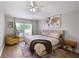 This bedroom features a queen-sized bed, fan, and natural light at 1833 Courtland St, Orlando, FL 32804