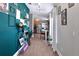 Hallway with appealing accent wall leads to a modern kitchen with stainless steel appliances at 1833 Courtland St, Orlando, FL 32804