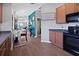 View of the kitchen with an open layout to the living spaces and unique decor at 1833 Courtland St, Orlando, FL 32804