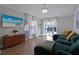 Living room with a comfortable sectional sofa and an art piece of beach scene at 1833 Courtland St, Orlando, FL 32804